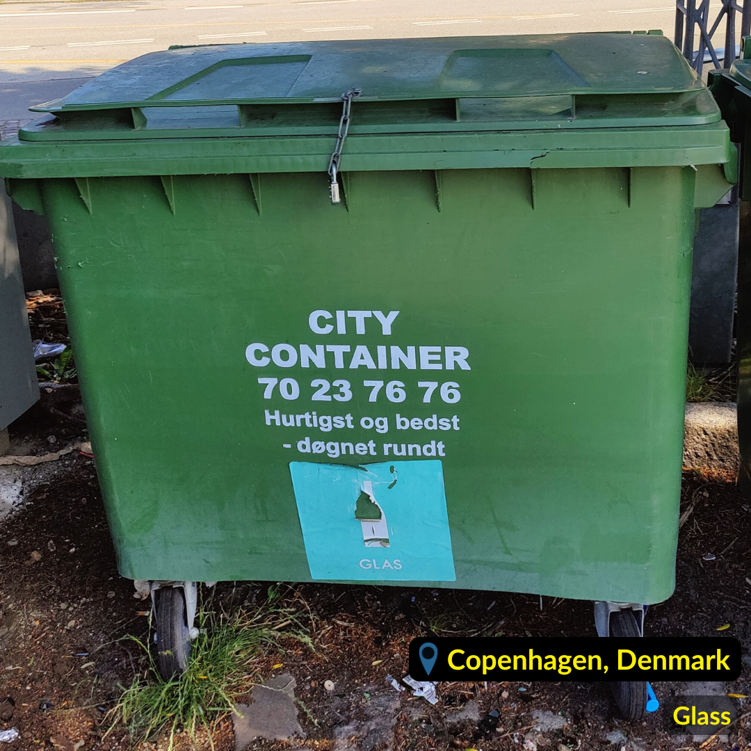 Green waste bin for Glass marked with blue label in Copenhagen Denmark